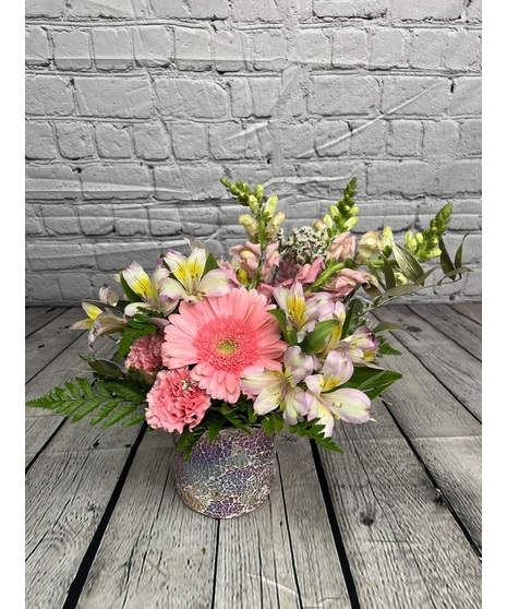 pink floral arrangement with moss purse, sparkles, and pink flowers