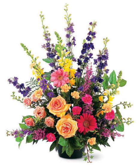 Bright basket of sympathy flowers appropriate for a service or for the home.