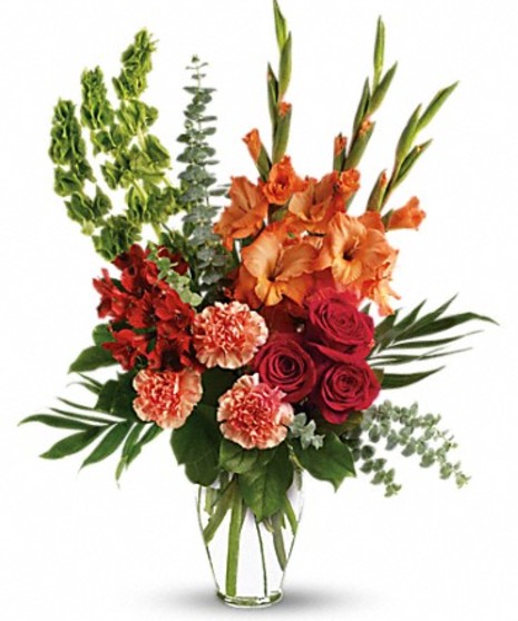Vase of red roses and alstroemeria, orange gladioli and carnations, bells of Ireland, and greenery.