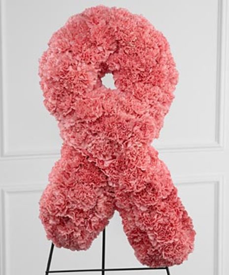 Sympathy arrangement of pink carnations in the shape of a breast cancer awareness ribbon.